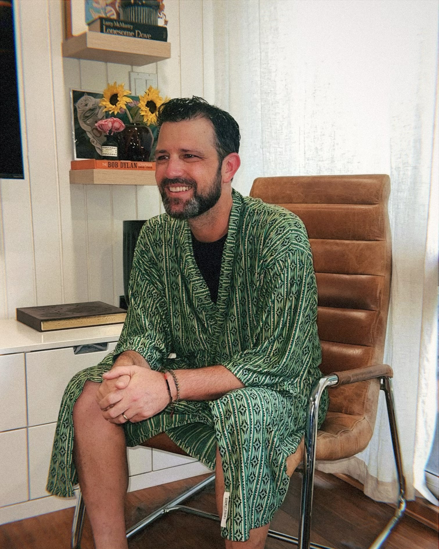 Man in green robe sitting in a chair