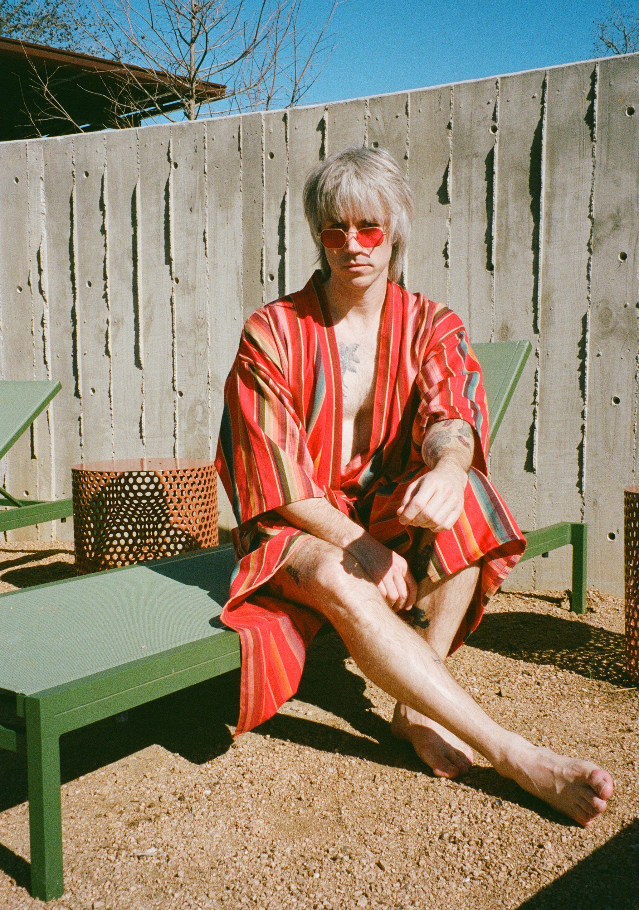 Man is red sarape robe