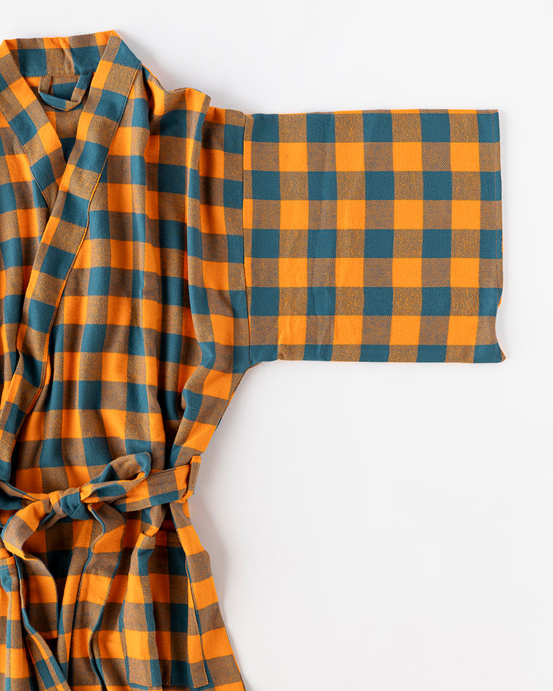 Plaid robe with blue and orange pattern on a white background